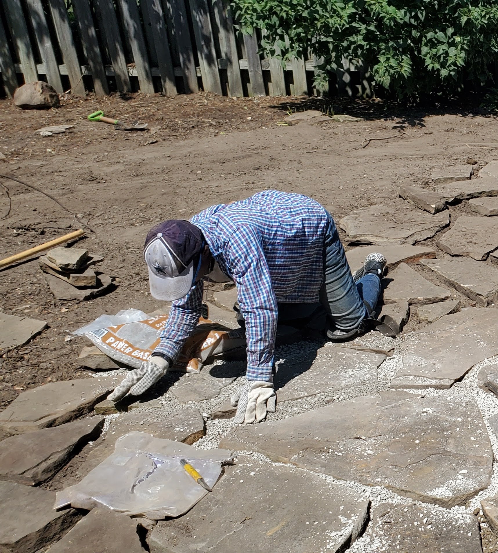 Niko, A CAS Environmental employee laying stone as the #1 Irrigation in Evansville